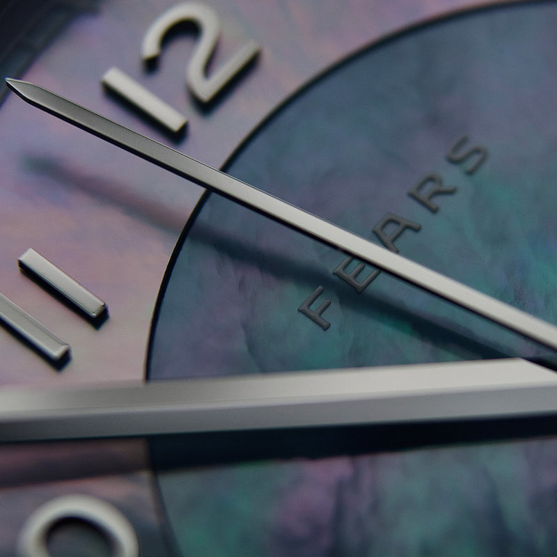A close view of the mother-of-pearl surface and applied numerals.